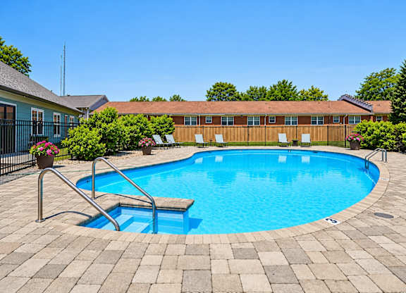 A small pool with a ladder in the middle of it.