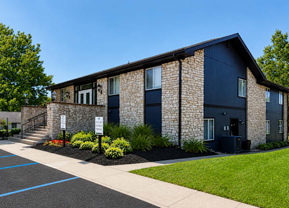 A building with a stone facade and dark blue trim.