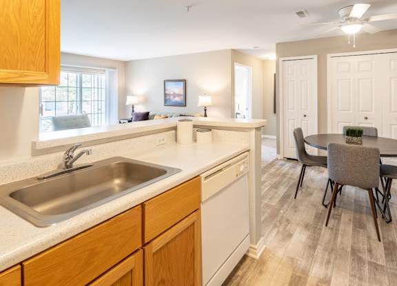 A kitchen with a table and chairs in the middle of the room.