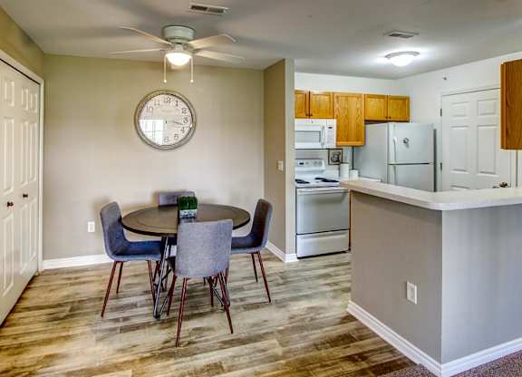 A kitchen with a table and chairs in the middle of the room.