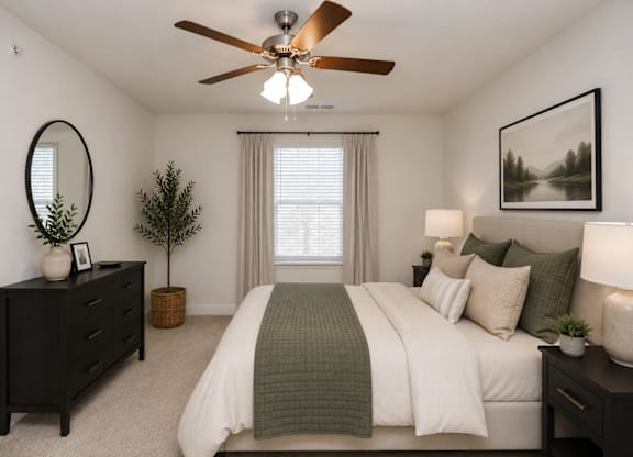 A bedroom with a bed, dresser, and a ceiling fan.