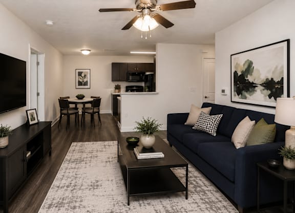 A living room with a dark blue couch and a coffee table.