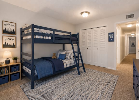 A bedroom with a bunk bed and a ladder.
