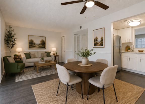 A dining room with a table set for four.