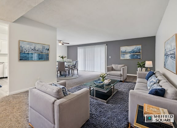 A living room with a grey couch and a coffee table.