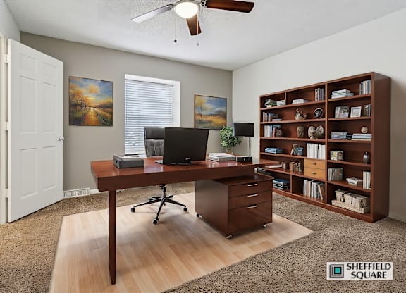 A room with a desk and a bookshelf.