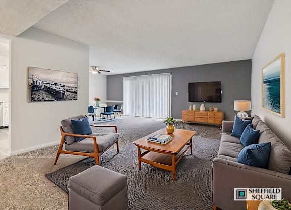 A living room with a sofa, chairs, and a coffee table.