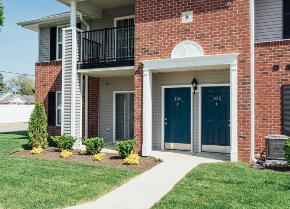 the view of the front of a brick building with blue doors
