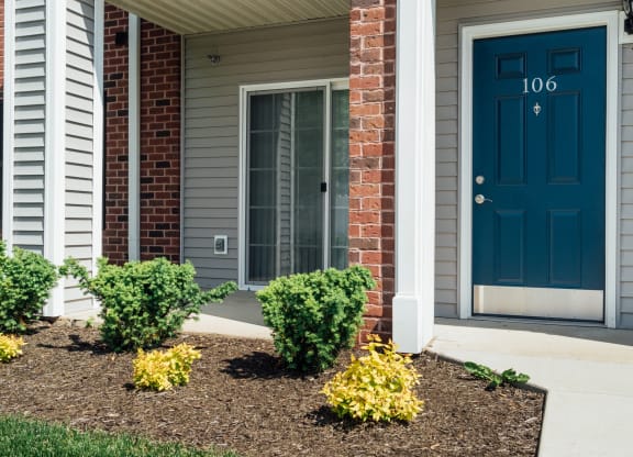 the front of a house with a blue door