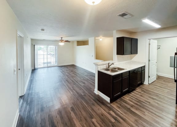 an empty living room and kitchen in an empty apartment