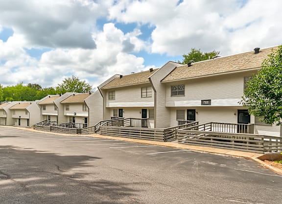 A row of white houses with black railings.