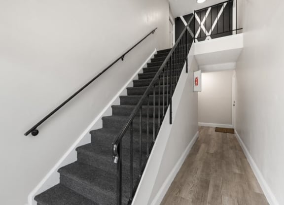 a view of the stairs from the bottom of the staircase in a home with white walls and