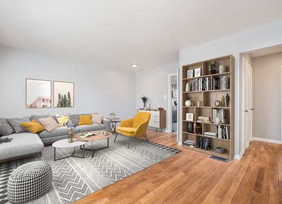 a living room with a couch and a book shelf