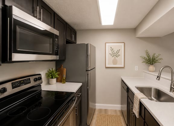 A kitchen with black appliances and a white counter.
