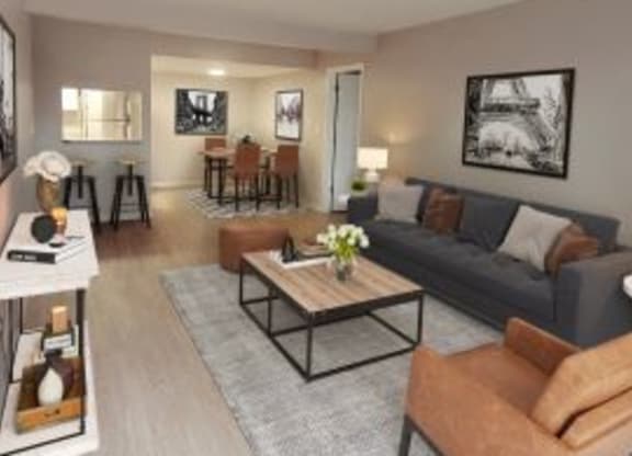 Spacious living room with hardwood-style flooring next to the dining area.  