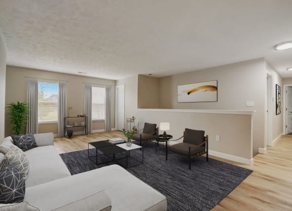 the living room of an apartment with a couch and chairs