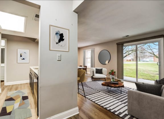 a living room with a couch and a rug and a sliding glass door