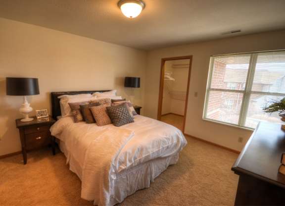 a bedroom with a large bed and a window
