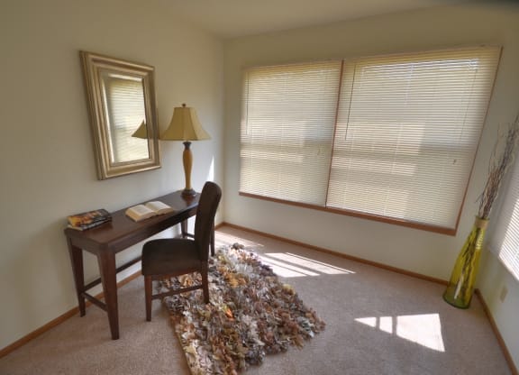 a home office with a desk and a lamp