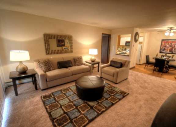 a living room with couches and chairs and a dining room table