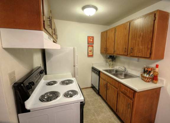 a kitchen with a stove refrigerator and sink