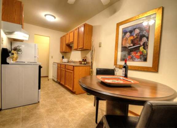 a kitchen and dining room with a table and a painting