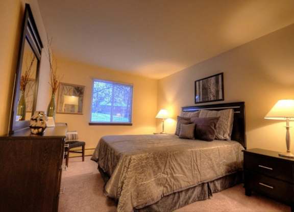 a bedroom with a large bed and a desk