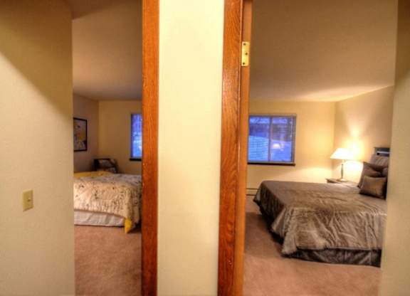 a bedroom with two beds and a window