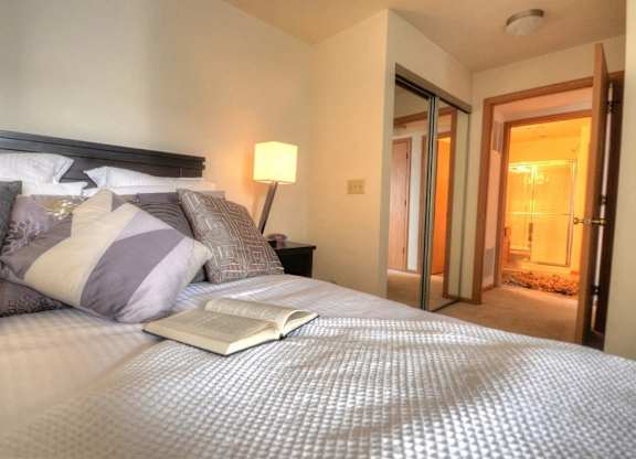 a bedroom with a bed with an open book on it
