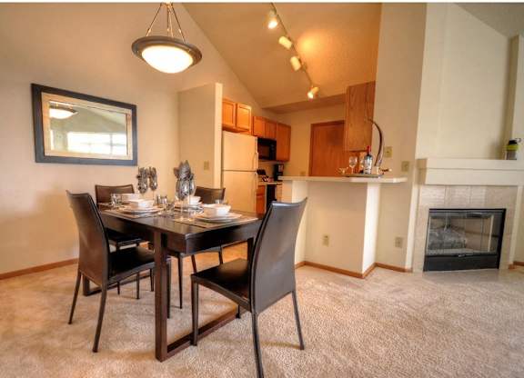 a dining room with a table and chairs and a fireplace