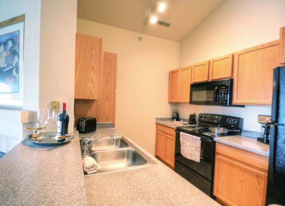 a kitchen with a sink and a stove and