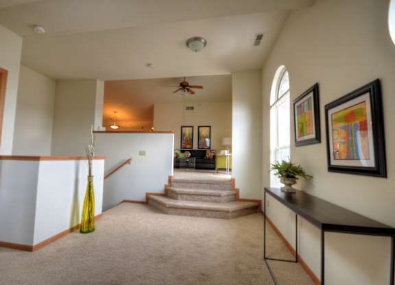 the view of the entryway from the living room into the dining room