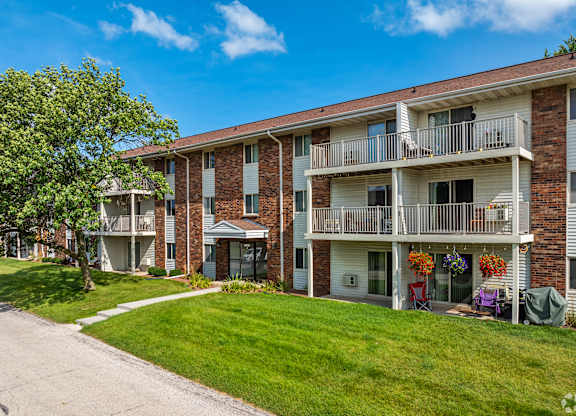 Apartment building with a tree in front of it.