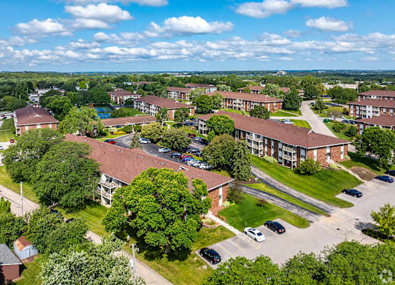 A bird's eye view of a residential area with houses and cars.