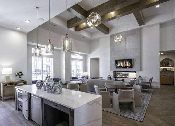 a large living room and dining room with a marble counter top