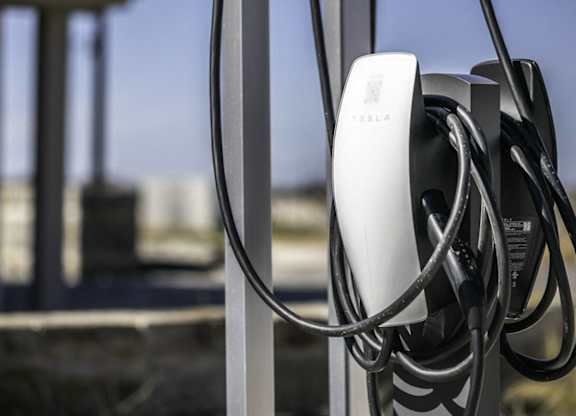 a power chord is plugged into a metal fence