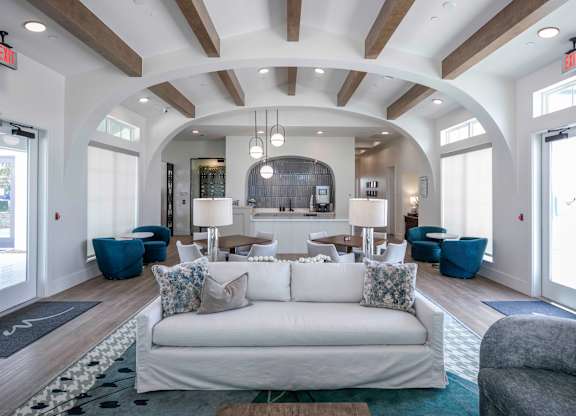 community room filled with furniture and a large windows