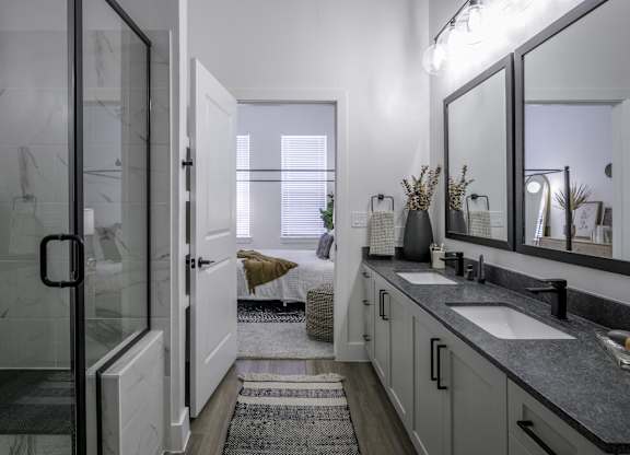 a bathroom with a sink and a shower and a mirror