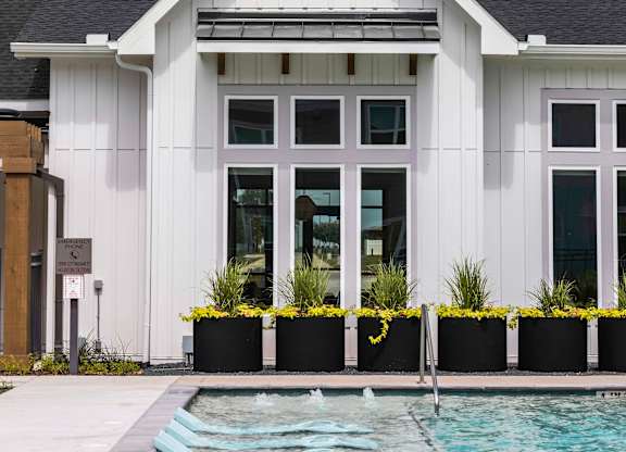 Clubhouse exterior with floating pool chairs