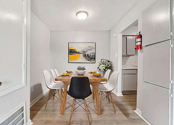 A dining room with a table set for four.