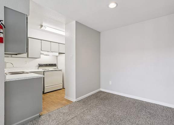 A small kitchen with white appliances and a white countertop.