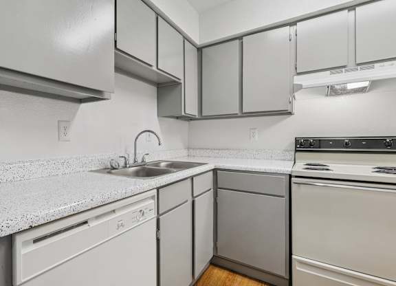 A kitchen with white appliances and cabinets.