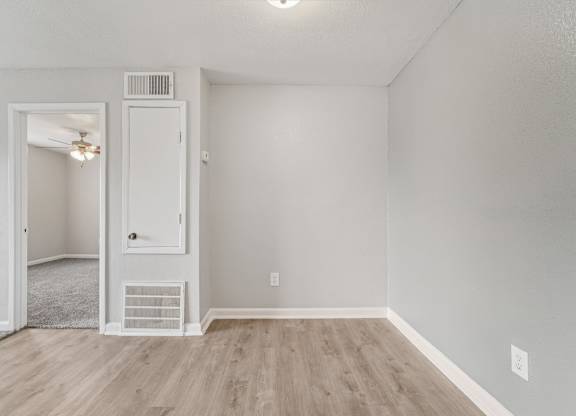 A room with a white door and a window.