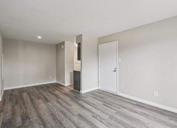 A room with a white door and a white wall.
