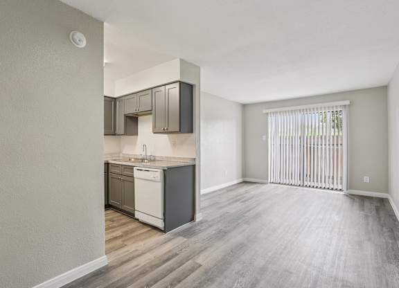 A kitchen with a white dishwasher and a white fridge.