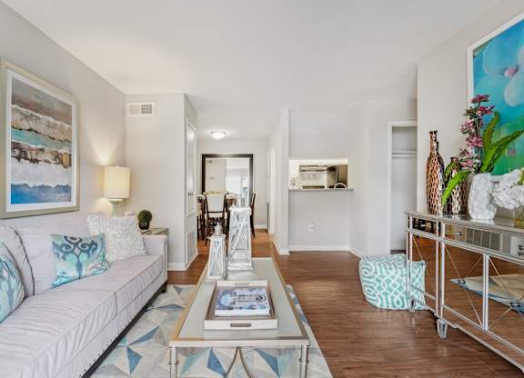 A living room with a white couch and a coffee table.