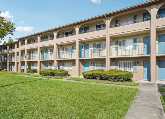 Apartment complex with blue doors and windows.