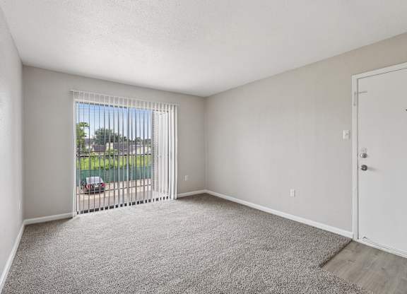 A room with a car parked outside the window.