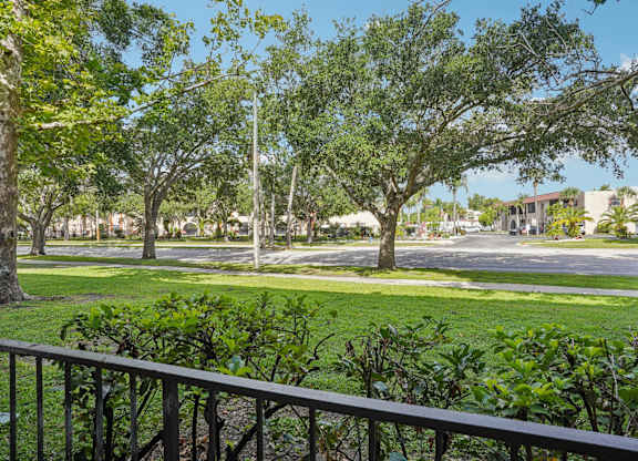 A view of a green lawn from a balcony.