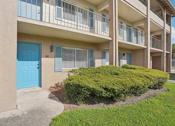 A blue door is on the left side of a building.